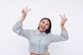 A lively and exuberant young asian woman makes a double peace sign. Feeling upbeat and elated. Isolated on a white background