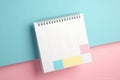 A lively image of a pink and yellow planner set against a vibrant bright blue background. Perfect for organization, crea Royalty Free Stock Photo