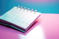 A lively image of a pink and yellow planner set against a vibrant bright blue background. Perfect for organization, crea Royalty Free Stock Photo