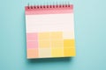 A lively image of a pink and yellow planner set against a vibrant bright blue background. Royalty Free Stock Photo