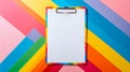 Colorful clipboard with blank paper against vibrant rainbow background Royalty Free Stock Photo