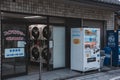 Lively street scene in Japan with a bustling laundry mat and a vending machine in Kyoto, Japan Royalty Free Stock Photo