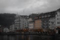 some building along the waterfront with many people walking around in front