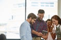 Liven up the working day with some laughter. a group of colleagues using a digital tablet together at work. Royalty Free Stock Photo