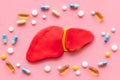 Liver diseases and treatment. Organ and pills on pink background top view