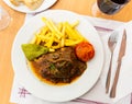 Liver meat with mushrooms, french fries and vegetables Royalty Free Stock Photo