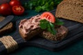 Liver meat pate spread on rye bread, breakfast, close-up, dark background. no people, selective focus, Royalty Free Stock Photo