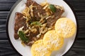 Liver with Onions Sage and Vinegar Fegato Alla Veneziana with polenta closeup in the plate. Horizontal top view Royalty Free Stock Photo