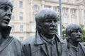 Sculpture of the Beatles on Pier Head, Liverpool, England, in rainy weather. Detail: Portrait of Paul, George and Ringo.