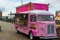 Liverpool, England, United Kingdom; 10/15/2018: Pink food truck offering donuts and waffles in Albert Dock