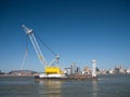 With the Liverpool Mersey waterfront behind, the craneship Lara 1 with electric powered FIGEE offshore 250 tonne crane