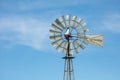 Closeup of a farm livestock watering windmill against a blue sky in northeastern Colorado