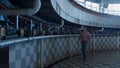 Livestock worker walking dairy facility. Farmer inspect milking carousel system Royalty Free Stock Photo