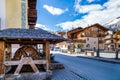 Livigno village, street view with old wooden water wheel, Italy, Alps Royalty Free Stock Photo