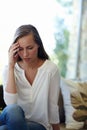 Living in the age of anxiety. A cropped shot of a stressed young woman sitting in her living room.