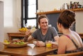 Living all natural. Shot of a happy couple with dreadlocks sitting down to breakfast. Royalty Free Stock Photo