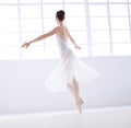 Living art. Graceful young ballerina in white dancing en pointe. Royalty Free Stock Photo