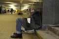 Living on the breadline. Homeless man hiding from the frost and snow in the underpass Royalty Free Stock Photo