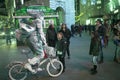 A living figure is a man in silver paint on a bicycle on Piccadilly in London at dusk