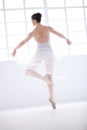 Living her dream. Graceful young ballerina in white dancing en pointe. Royalty Free Stock Photo