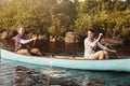 Living that laid back life at the lake. a young couple going for a canoe ride on the lake.