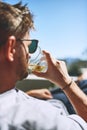 Living in my element. a relaxed young man having a drink while looking at the view from his balcony outside at home Royalty Free Stock Photo