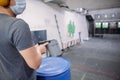 Living in a pandemic. A man in a medical mask aims at a target with a gun at a shooting range amid a pandemic. Royalty Free Stock Photo