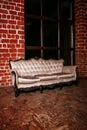 Living room with beige sofa on the red brick wall Royalty Free Stock Photo