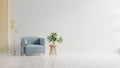 Living room with blue fabric armchair on empty white wall background Royalty Free Stock Photo