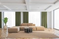 Living room with brown and green design, sofa with carpet and big windows Royalty Free Stock Photo