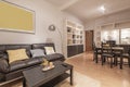 Living room with brown leather sofa, dark coffee table, wooden