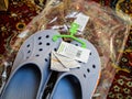 Living room carpet with pair of new Crocs sandals foam clogs in