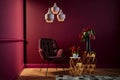 Living room with chair and side table, designer pendant lamp in front of burgundy wall, 3d rendering, 3d illustration, copy space Royalty Free Stock Photo