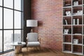 Living room with chair, table, shelf with book