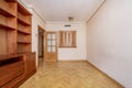 Living room with cherry colored wood furniture on one side and access Royalty Free Stock Photo