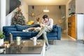 Man and his dog are sitting in the living room with Christmas decorations Royalty Free Stock Photo