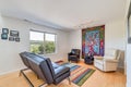 Living room with colorful carpet window overlooking forest city and water view