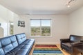 Living room with colorful carpet window overlooking forest city and water view