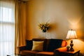 A living room with a couch, lamp and a window, warm colored. Royalty Free Stock Photo