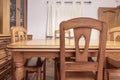 A living room with a custom wooden sideboard on one wall, chestnut wood floors and a dining table with matching chairs with fabric Royalty Free Stock Photo