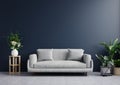 Living room with dark blue walls is empty, decorated with plants and sofas on tiled floors.3d rendering Royalty Free Stock Photo