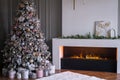 Living room with decorated Christmas tree, gifts and fireplace Royalty Free Stock Photo