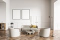 Living room design interior. Modern stylish home area. Two framed mock up posters on white wall. Wooden parquet floor. Armchairs Royalty Free Stock Photo