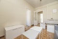 Living room with dining table with tablecloth, gray two-seater sofa,