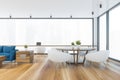 Living room and dining room with white armchairs