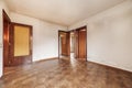 Living room of an empty apartment with cheap dark wood carpentry and brown tile floors Royalty Free Stock Photo