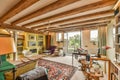 a living room with exposed beams and a large window Royalty Free Stock Photo