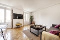 Living room with fabric sofa, dark wood side table, herringbone Royalty Free Stock Photo