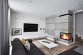 Living room with fireplace and white concrete brown walls
