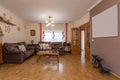 Living room furnished with somewhat kitschy decoration with wooden coffee tables